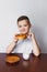 A boy, a kitchen, a bagel and milk. Healthy breakfast.