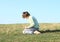 Boy kneeling on meadow