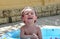 Boy laughing hard in inflatable pool