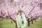 Boy laughing standing in flowering trees