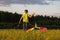 The boy launches a kite. Summer day. Sunny.The boy in a yellow t-shirt with a kite