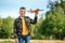 The boy launches a toy airplane against the backdrop of greenery. The concept of dreams, choice of profession, pilot, childhood.