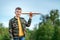 The boy launches a toy airplane against the backdrop of greenery. The concept of dreams, choice of profession, pilot, childhood.