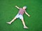 Boy laying on plastic green grass