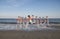 Boy leaping in motion on a beach