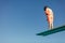 Boy learning on diving spring board