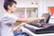 Boy learning music online. Child watching video tutorial at tablet computer and playing digital piano at home