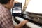 A boy is learning piano online with a tablet by the social network