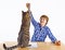 Boy learning for school has a break and plays with his cat