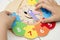 Boy learning time with wooden clock.