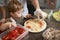 Boy learning to cook pizza with chef