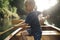 Boy learning to paddle canoe on a lake