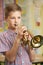 Boy Learning To Play Trumpet In School Music Lesson