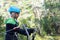 Boy learning to use carabiner of safety equipment