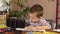 Boy learns remotely by smartphone.Little boy sits at the table. Distance learning during quarantine.