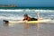 A boy learns to surf on a board