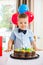 Boy Licking Lips While Looking At Birthday Cake