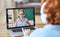 Boy listening to friendly teacher during online lesson