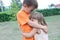 Boy and little girl embracing. happy siblings