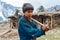 Boy living in the Himalayas holding an axe