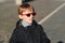 Boy with lollipop. Preteen boy having fun outdoors. Boy wearing trendy sunglasses. Urban street style