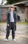 Boy in Long Coat Standing in a Farm Yard