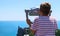 Boy looking in binoculars on an observation castle