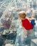 Boy looking down at city from a skyscarper