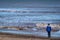 Boy looking out to sea on a Norfolk beach