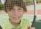 Boy Looking Through Tennis Racket