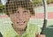 Boy Looking Through Tennis Racket portrait close up