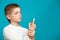 Boy looking at white adhesive plaster on his thumb