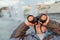 Boy looks through binoculars at sunset