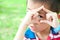 Boy looks through a framework from hands