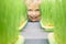 Boy looks out from behind sprouted green wheat grains on a micro-greenery farm