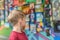 The boy looks at the paintings in the exhibition gallery