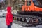 A boy looks at a snowcat at a ski resort