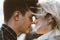 The boy looks tenderly at girl and wants to kiss. A young couple stands embracing. The concept of teenage love and first kiss,