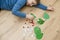 Boy lying on the floor and playing homemade counting game ` ladybird on the leaf `.