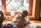 Boy lying on floor on sheepskin and looking in window, lost in dreams or boring