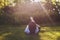 Boy lying on the grass and show thumbs up signal