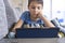 Boy lying on sofa with digital tablet computer at home. Technology, ditance education, online learning, playing games