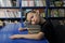 Boy lying tired on pile of book in library don`t want to learning