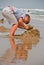 Boy made sandcastle on beach