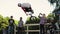 Boy make extreme back flips on BMX bicycle in skate park. Summer. Audience.