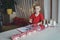 Boy makes crafted advent calendar on theme of skis and cable car with toilet paper rolls at home