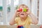 The boy makes eyes of colorful children`s blocks. Cute little kid boy with glasses playing with lots of colorful plastic