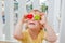 The boy makes eyes of colorful children`s blocks. Cute little kid boy with glasses playing with lots of colorful plastic blocks in