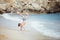 A boy making a cartwheel in the sea surf