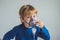 Boy making inhalation with a nebulizer at home